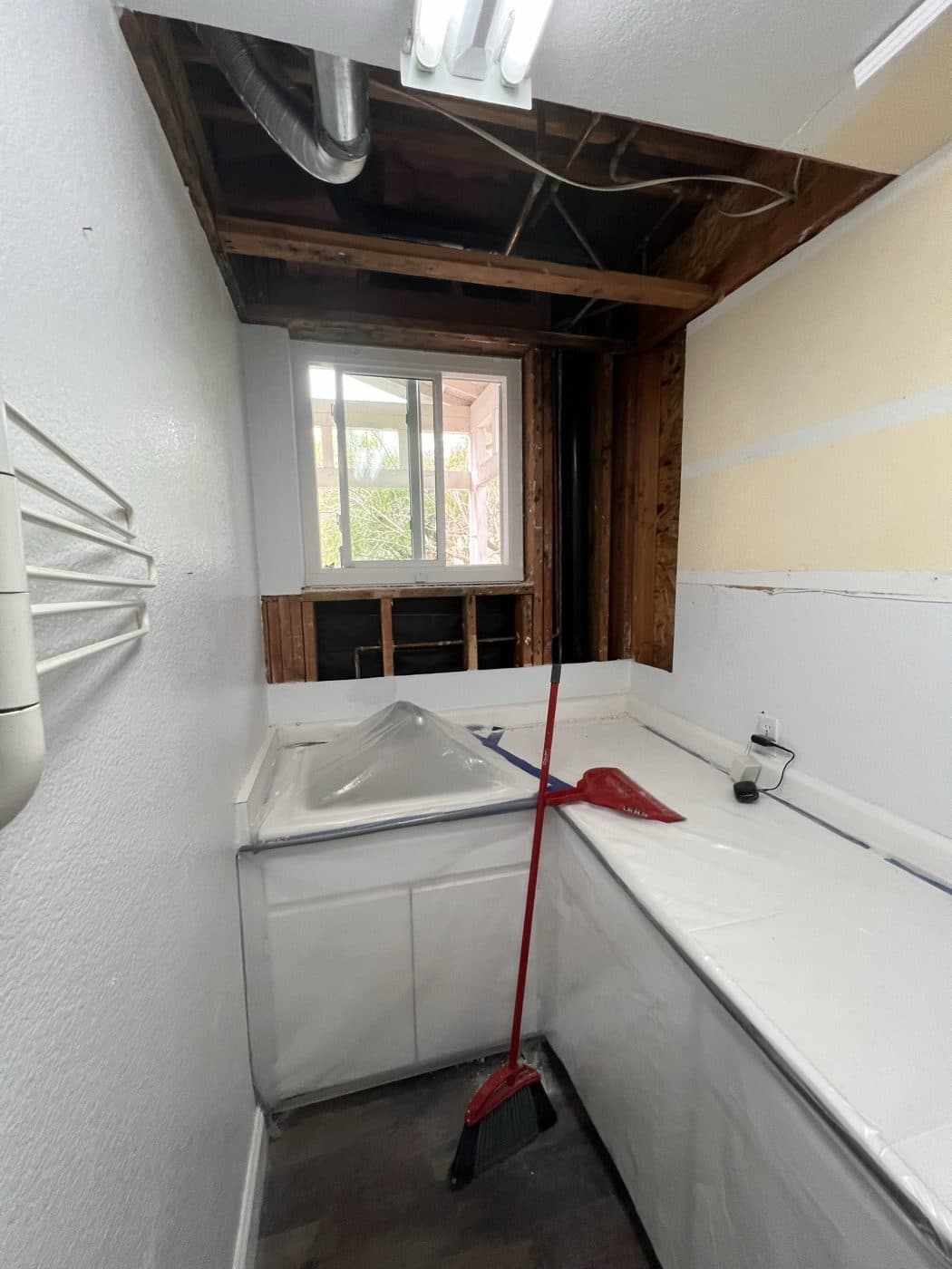 Fire-damaged ceiling and wall framing exposed for restoration assessment