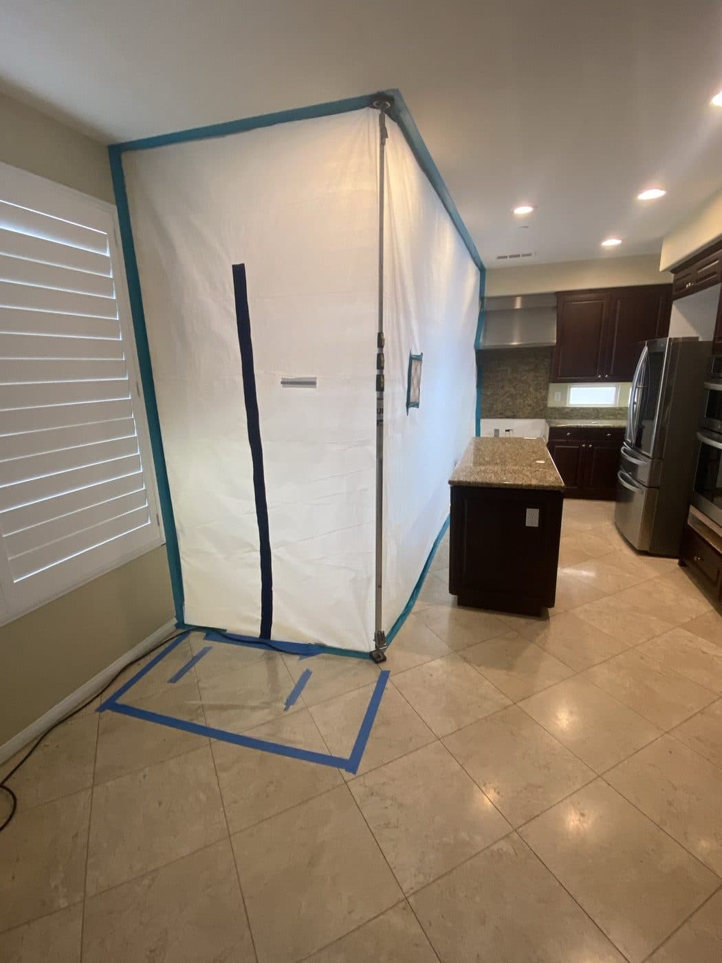 Full containment tent set up in a high-end kitchen for mold remediation